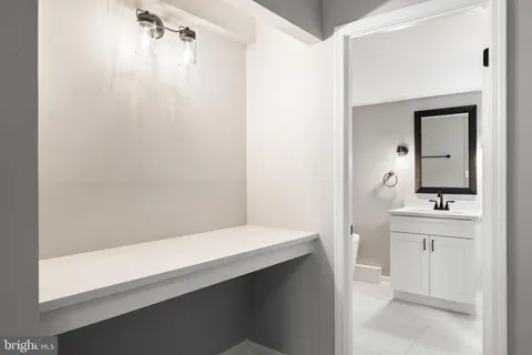 a bathroom with a bathtub sink and mirror