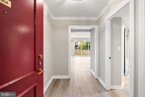 a view of a hallway with wooden floor