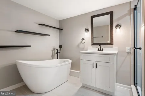 a white bath tub sitting next to a white sink