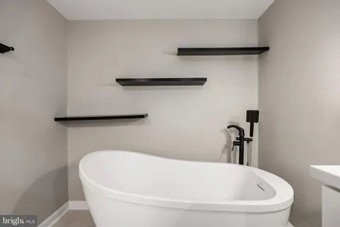 a white bath tub sitting in a bathroom