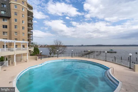 a view of a swimming pool with a table and chairs