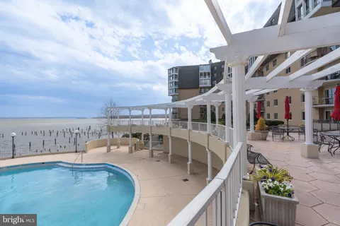 swimming view of a swimming pool with a lounge chair
