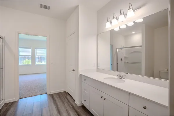a bathroom with a double vanity sink and a mirror