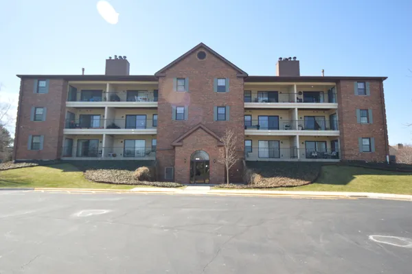 a front view of a building with a swimming pool