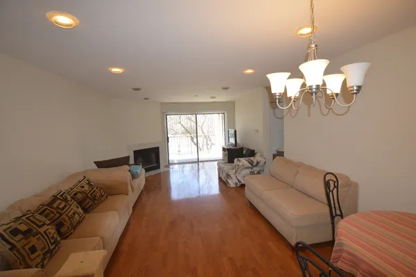 a living room with furniture chandelier and a window