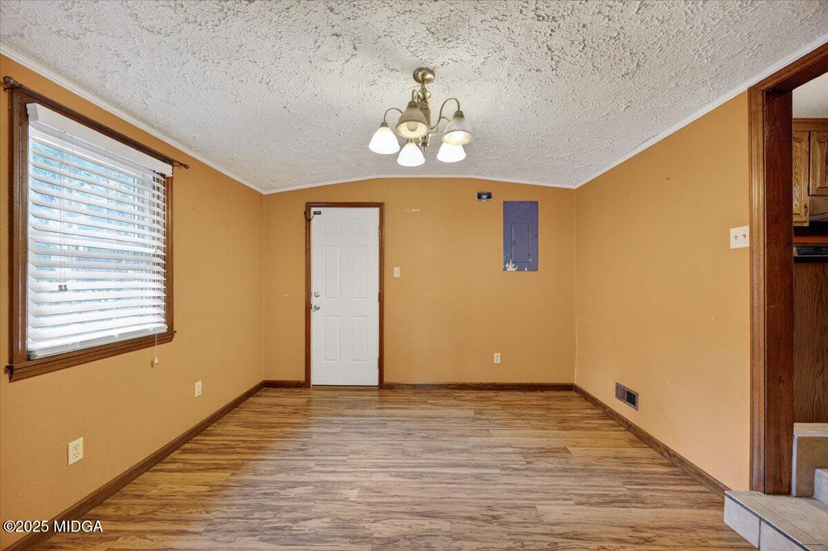 5682 Hartley Bridge Road Macon, GA 31216 - Photo 13 of 79 a view of an empty room with wooden floor and a window