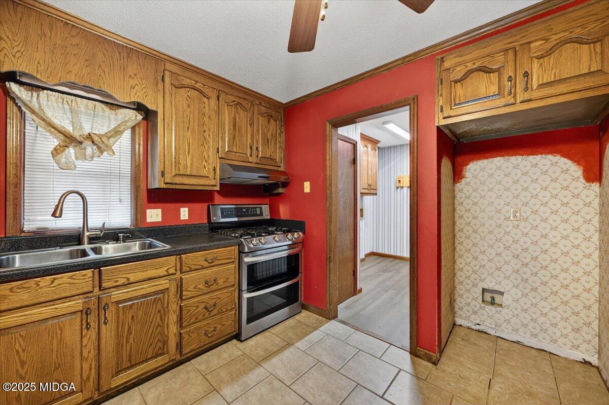 5682 Hartley Bridge Road Macon, GA 31216 - Photo 14 of 79 a kitchen with stainless steel appliances granite countertop a stove and a sink