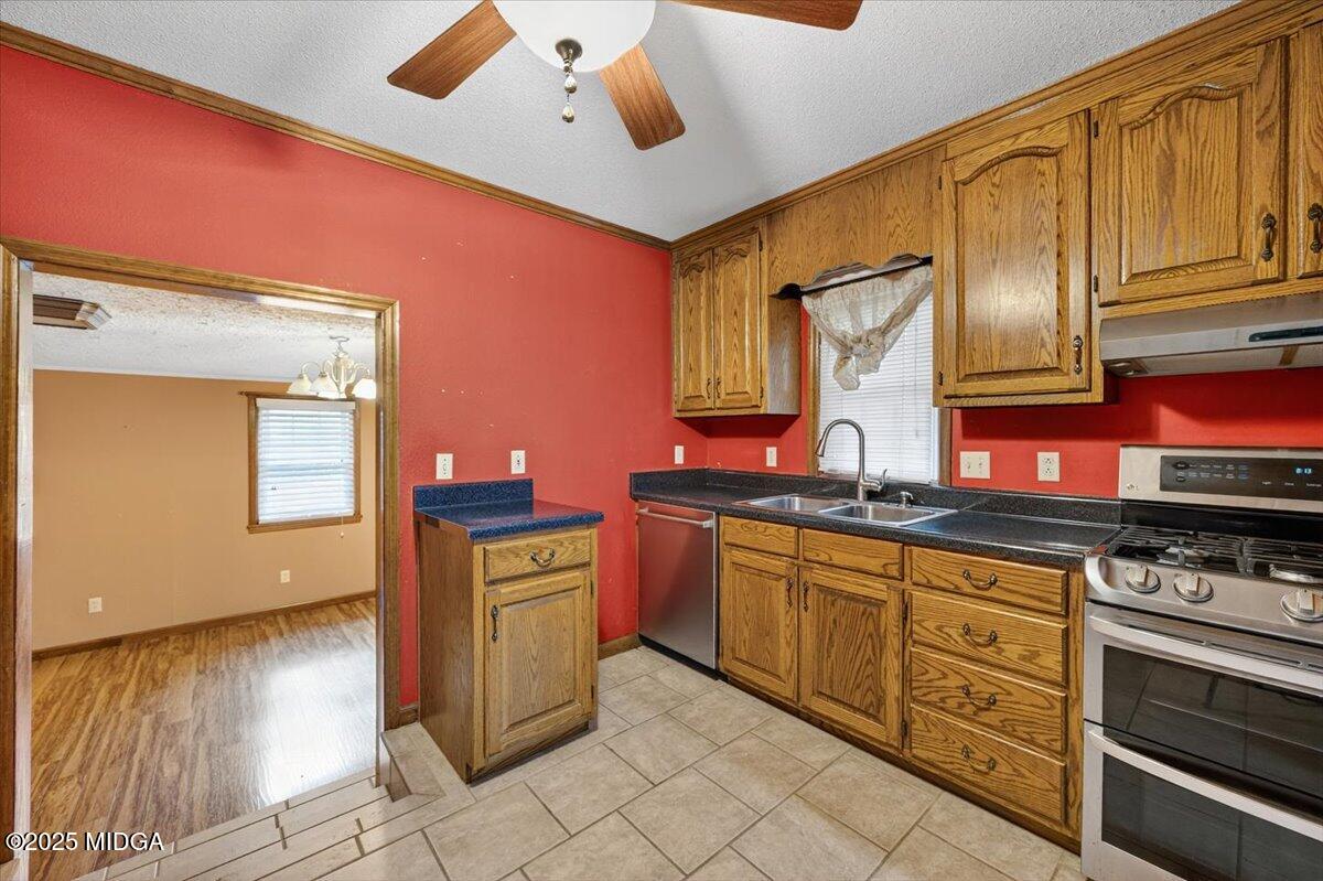5682 Hartley Bridge Road Macon, GA 31216 - Photo 15 of 79 a kitchen with stainless steel appliances granite countertop a stove and cabinets