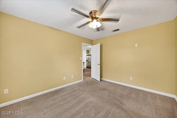 a bathroom with a granite countertop toilet and a shower
