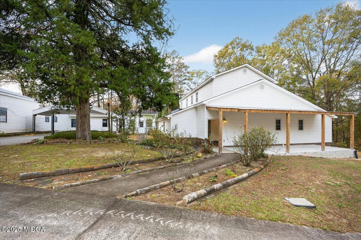 5682 Hartley Bridge Road Macon, GA 31216 - Photo 3 of 79 a view of a yard in front of a house