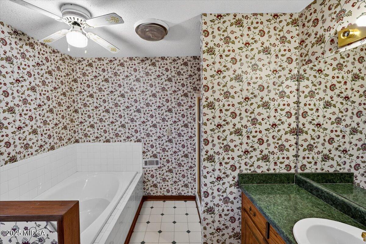 5682 Hartley Bridge Road Macon, GA 31216 - Photo 32 of 79 a bathroom with a bathtub and shower