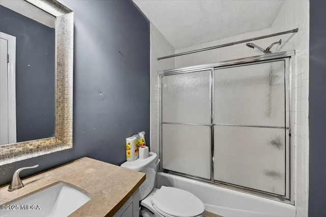 an empty room with closet and windows