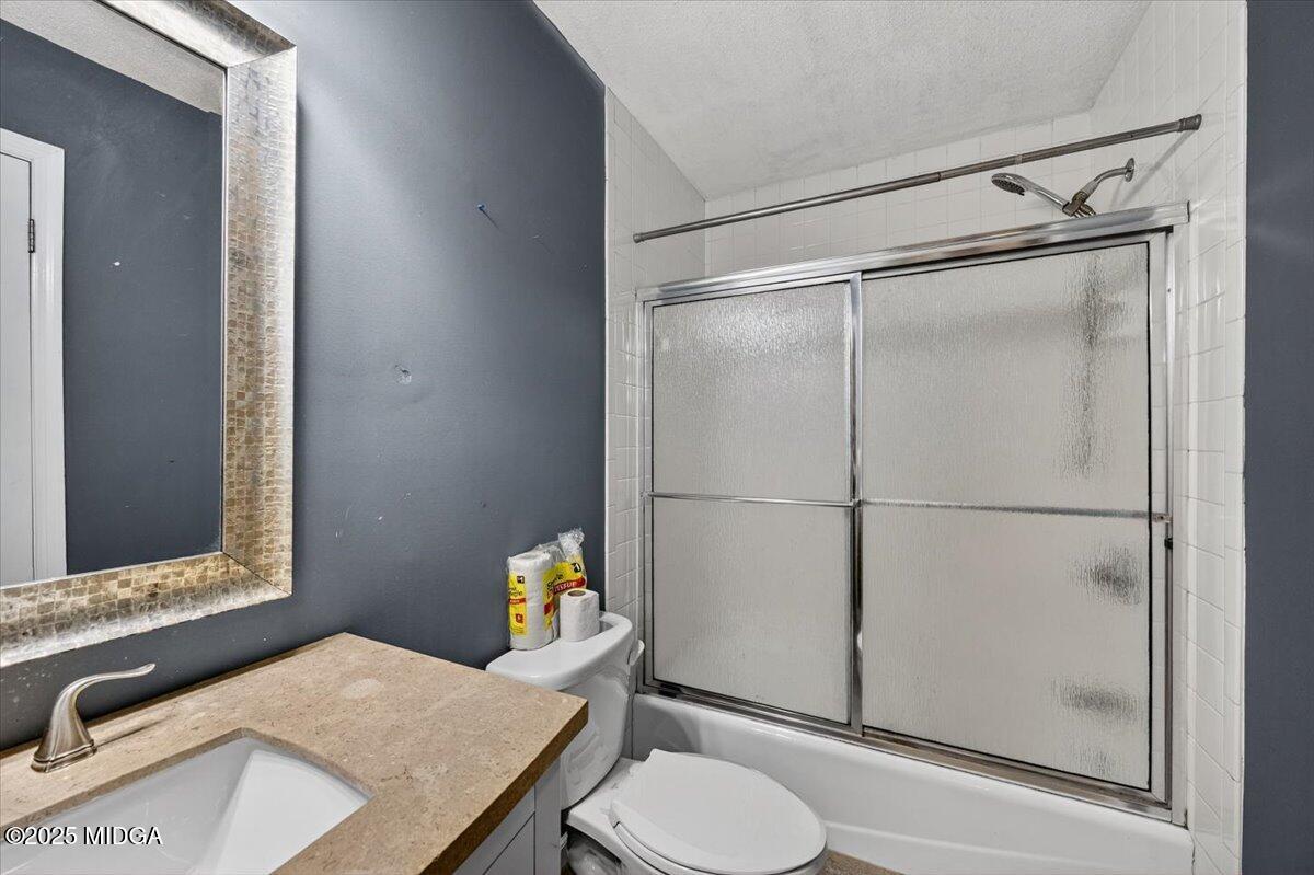 5682 Hartley Bridge Road Macon, GA 31216 - Photo 34 of 79 a bathroom with a sink toilet and shower