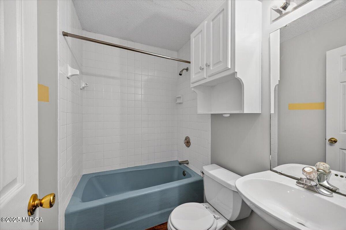 5682 Hartley Bridge Road Macon, GA 31216 - Photo 38 of 79 a bathroom with a sink toilet and shower