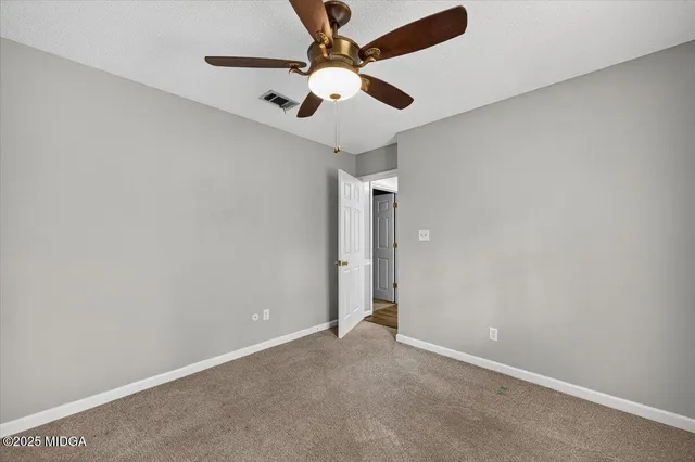 a view of a house with a yard and garage