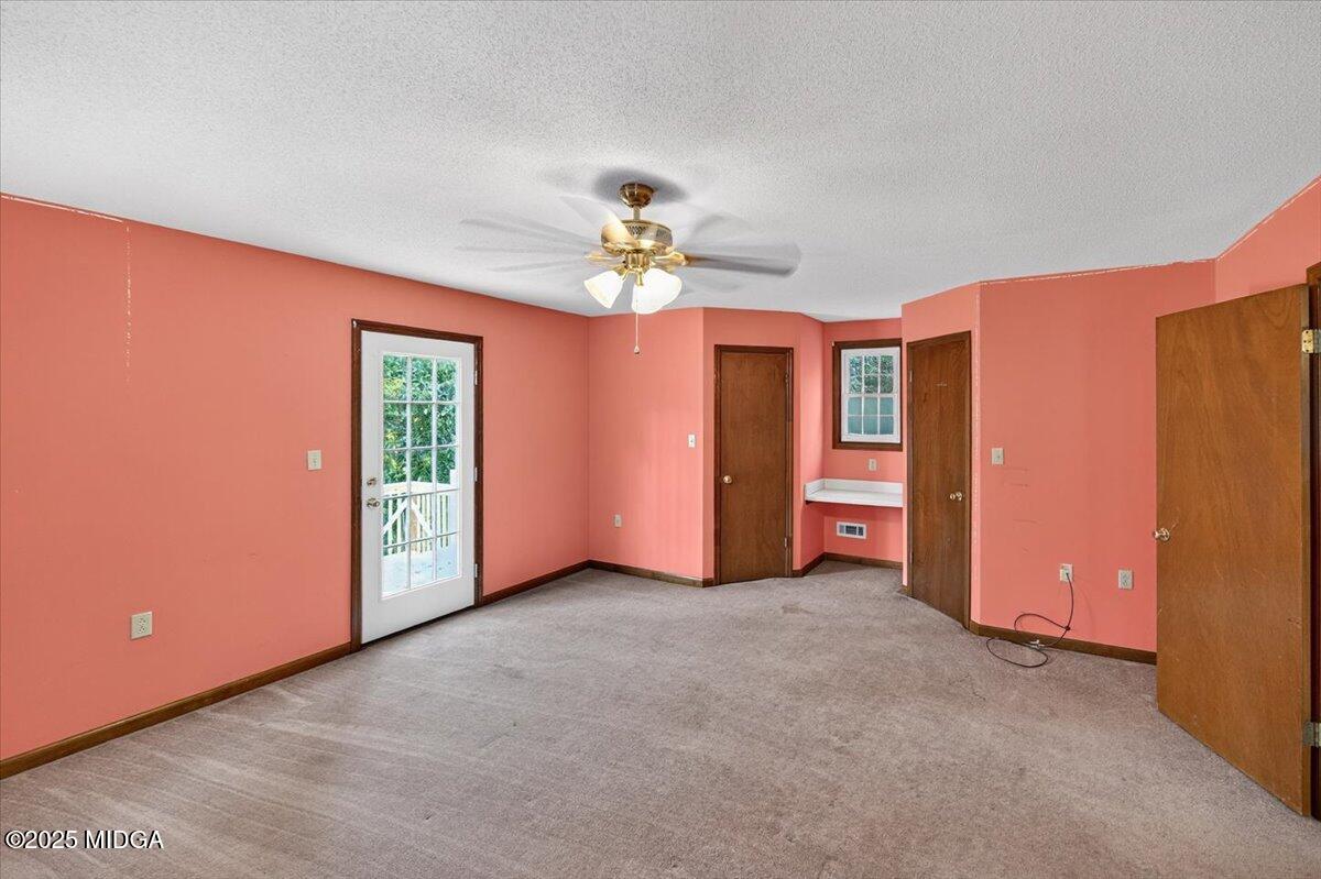 5682 Hartley Bridge Road Macon, GA 31216 - Photo 42 of 79 an empty room with closet and windows