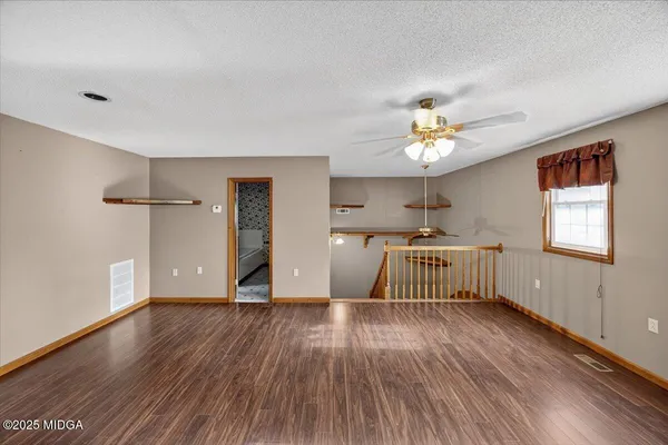 a view of a porch with wooden floor and stairs