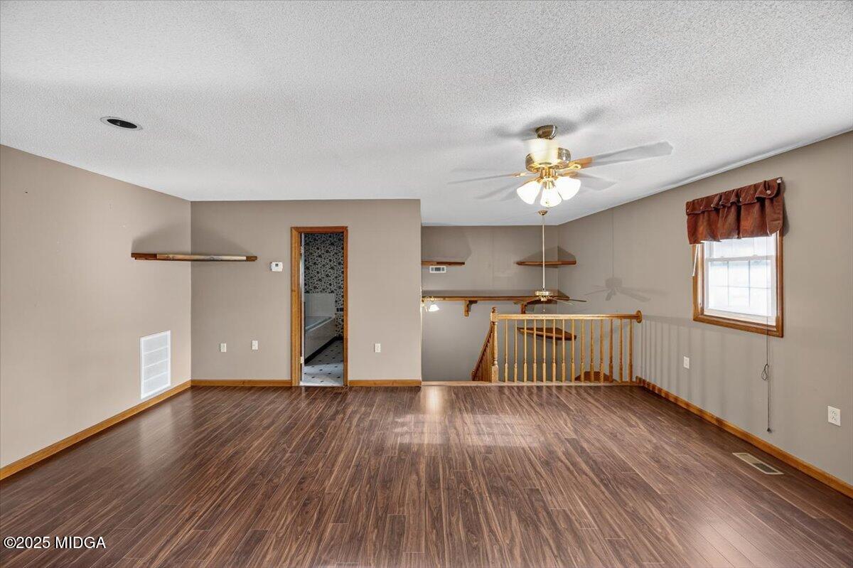 5682 Hartley Bridge Road Macon, GA 31216 - Photo 43 of 79 a view of an empty room with a window and wooden floor