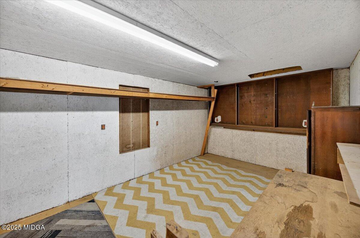 5682 Hartley Bridge Road Macon, GA 31216 - Photo 49 of 79 a bedroom with a bed and a cabinets