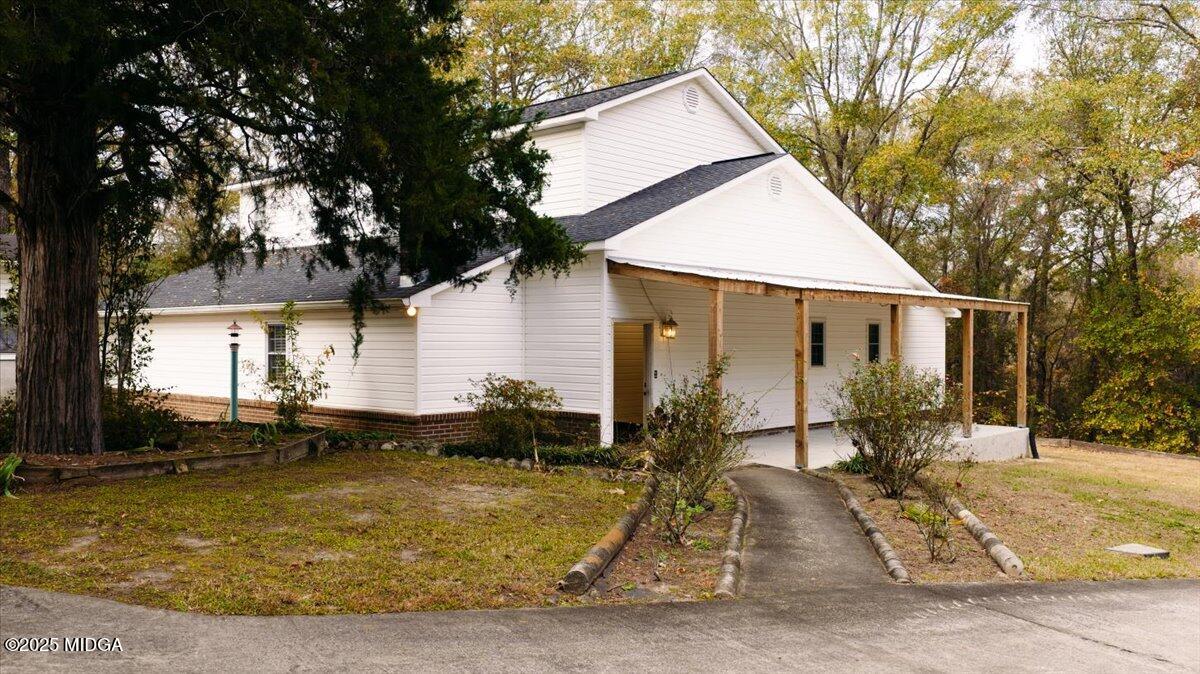 5682 Hartley Bridge Road Macon, GA 31216 - Photo 5 of 79 a view of a house with backyard and sitting area