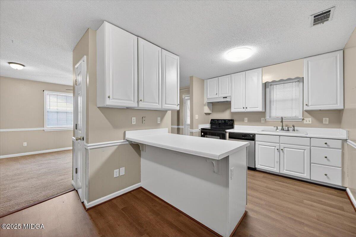 5682 Hartley Bridge Road Macon, GA 31216 - Photo 63 of 79 a kitchen with granite countertop white cabinets and white appliances