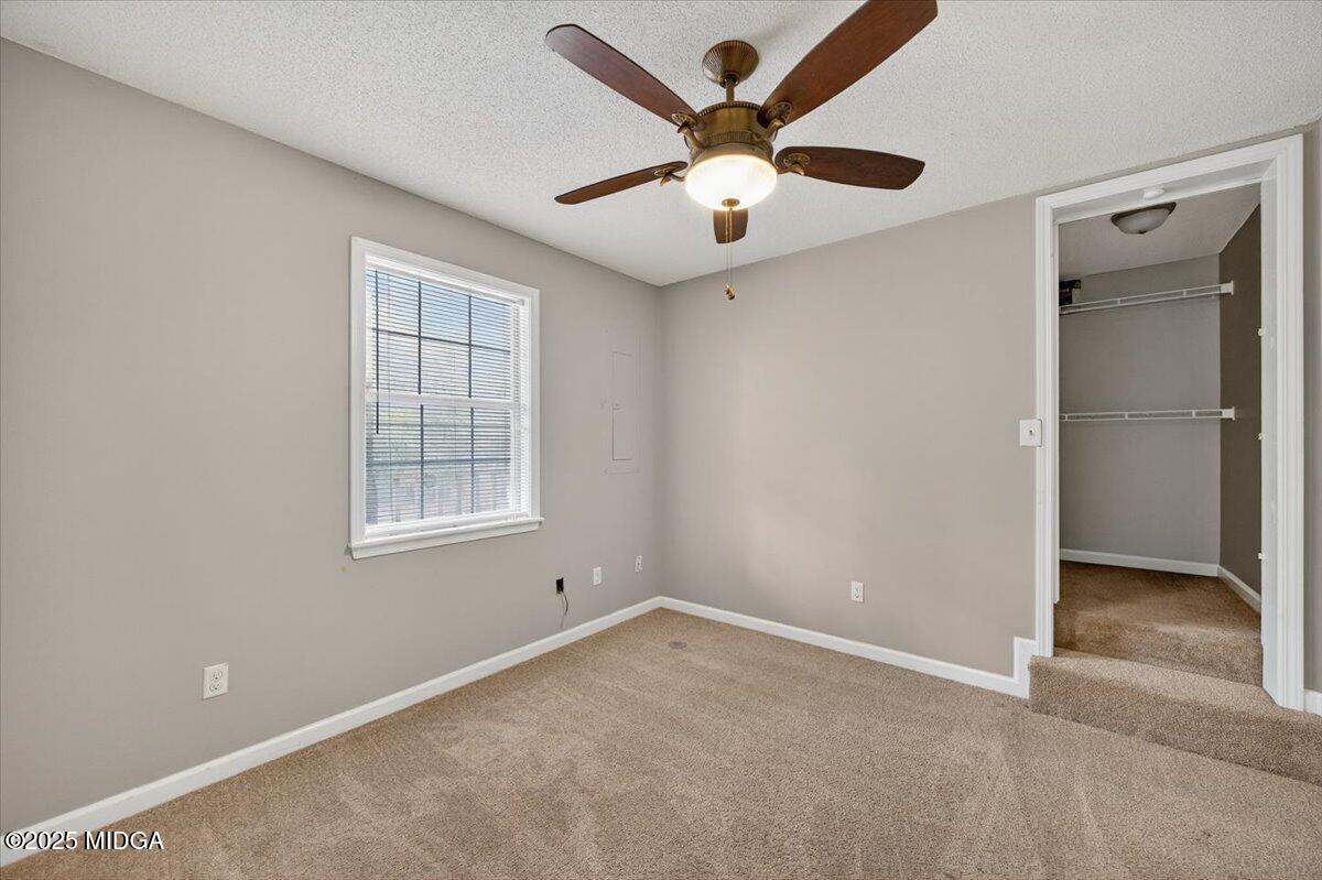 5682 Hartley Bridge Road Macon, GA 31216 - Photo 66 of 79 an empty room with a window and a ceiling fan