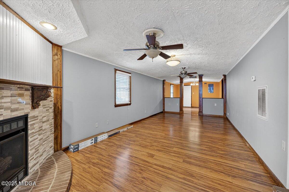 5682 Hartley Bridge Road Macon, GA 31216 - Photo 10 of 79 a view of a livingroom with wooden floor and a ceiling fan