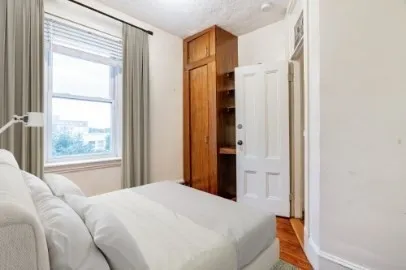 a bedroom with a bed and a window