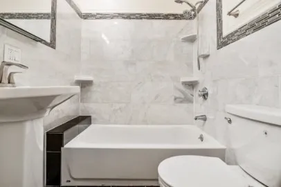 a bathroom with a sink a toilet and bathtub