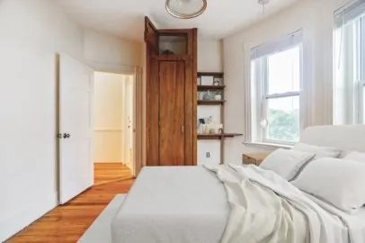 a bedroom with a bed and a window