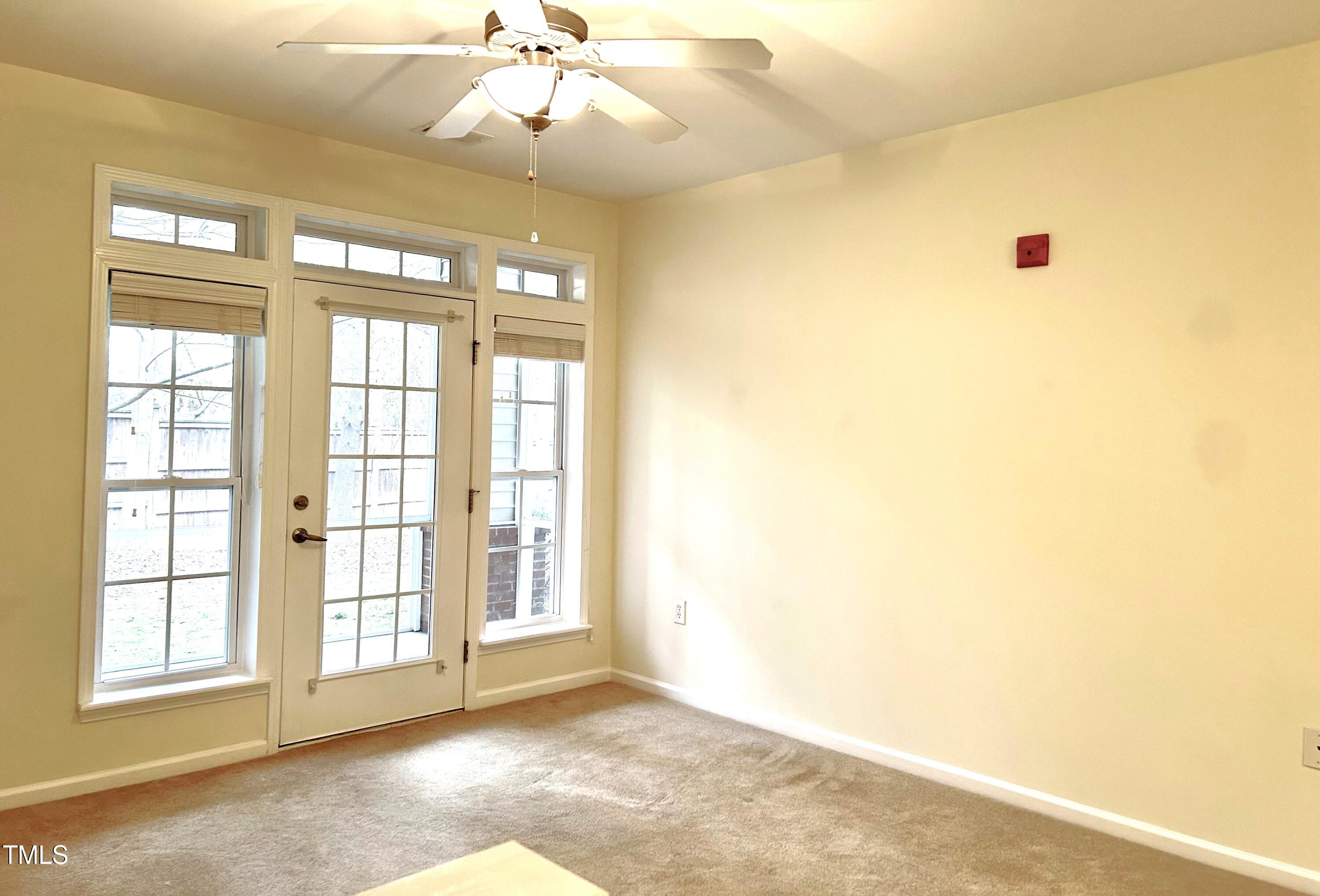 512 Weather Ridge Lane, Unit 2 Cary, NC 27513 - Photo 5 of 22 Living Room with Ceiling fan and access to Screened Porch and Storage Room
