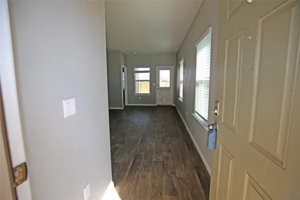 a view of an empty room with a kitchen