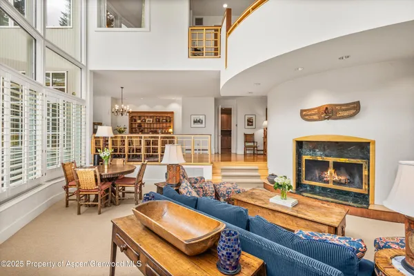 a living room with furniture and a floor to ceiling window