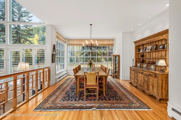 a view of a dining room with furniture window and wooden floor