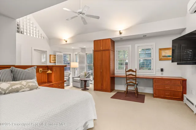 a bedroom with a large bed and a window