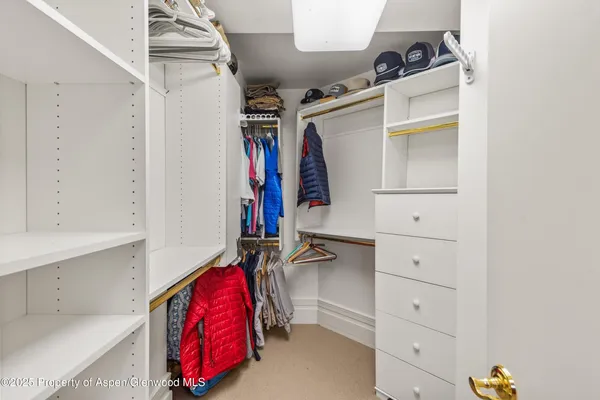 a spacious bedroom with a bed and a large window with the outer view