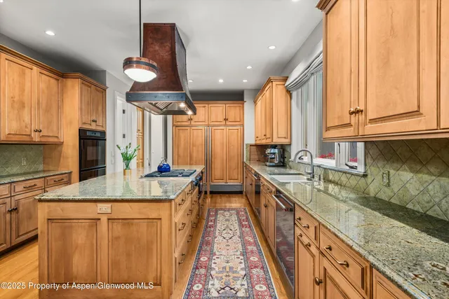 a kitchen with a stove sink and cabinets