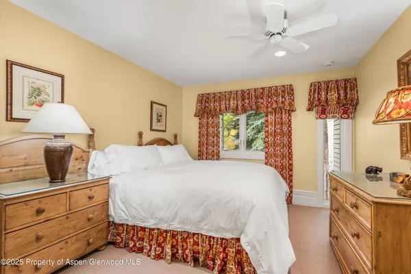 a bathroom with a granite countertop sink a toilet and a mirror