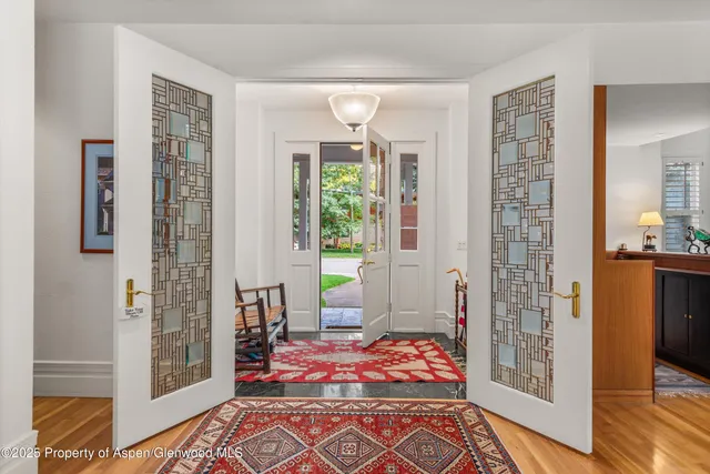 a room with furniture a flat screen tv and a window