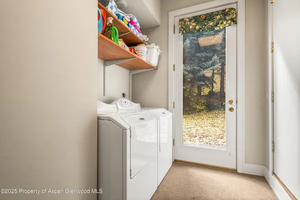 a white house that has a tree in front of it