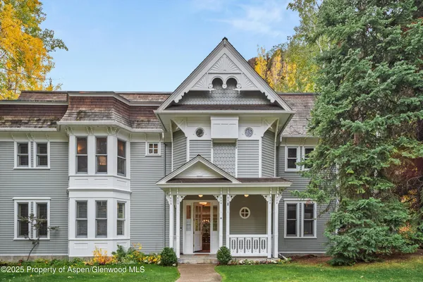 a front view of a residential houses with yard