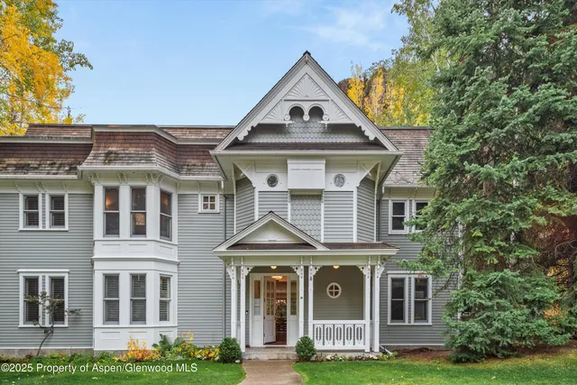 a front view of a residential houses with yard