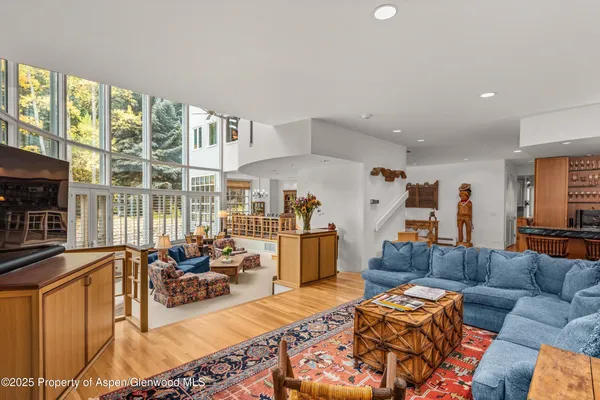 a living room with furniture and a floor to ceiling window