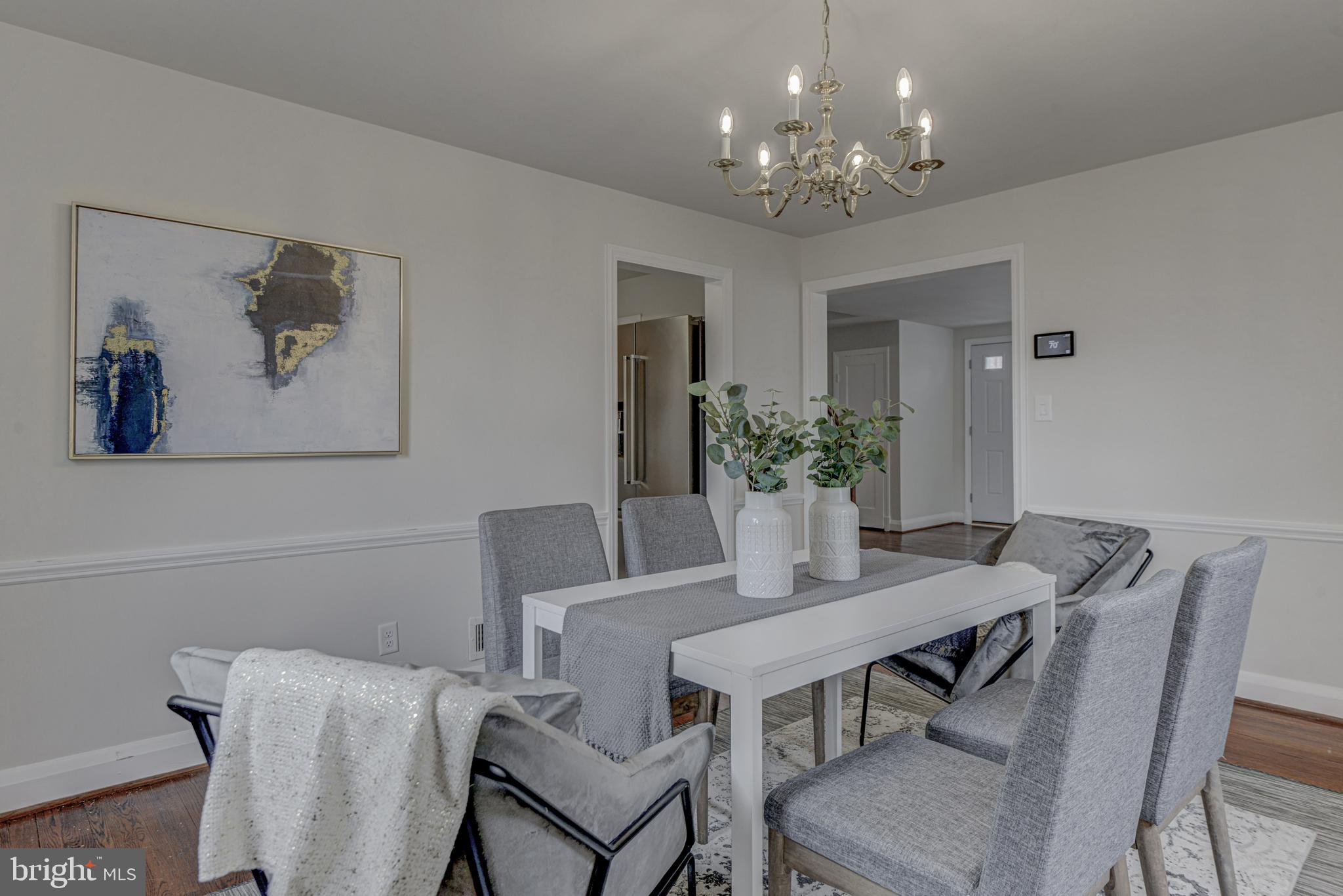 6121 Regent Park Road Baltimore, MD 21228 - Photo 12 of 36 a view of a dining room with furniture and chandelier