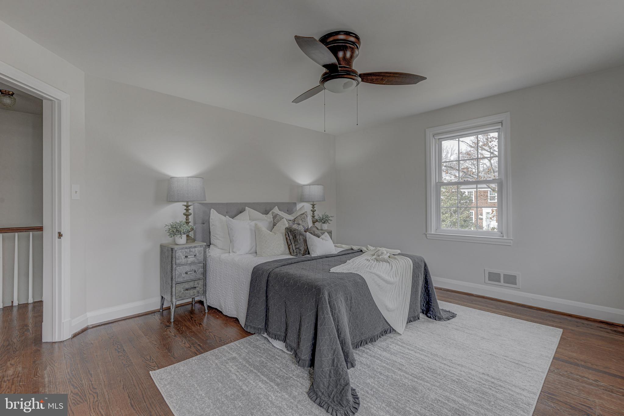 6121 Regent Park Road Baltimore, MD 21228 - Photo 22 of 36 a bedroom with a bed and wooden floor