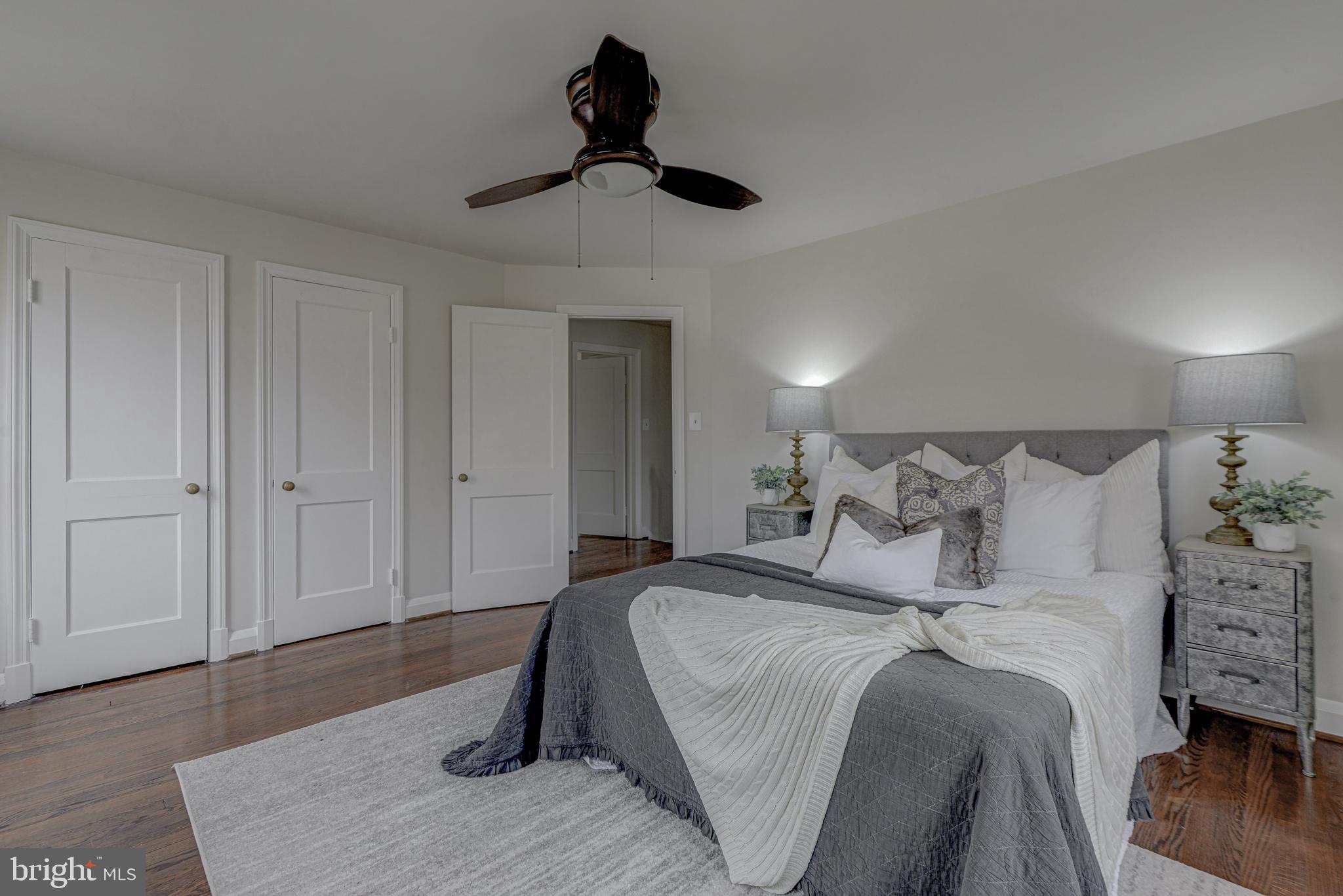 6121 Regent Park Road Baltimore, MD 21228 - Photo 23 of 36 a bedroom with a bed and a chandelier