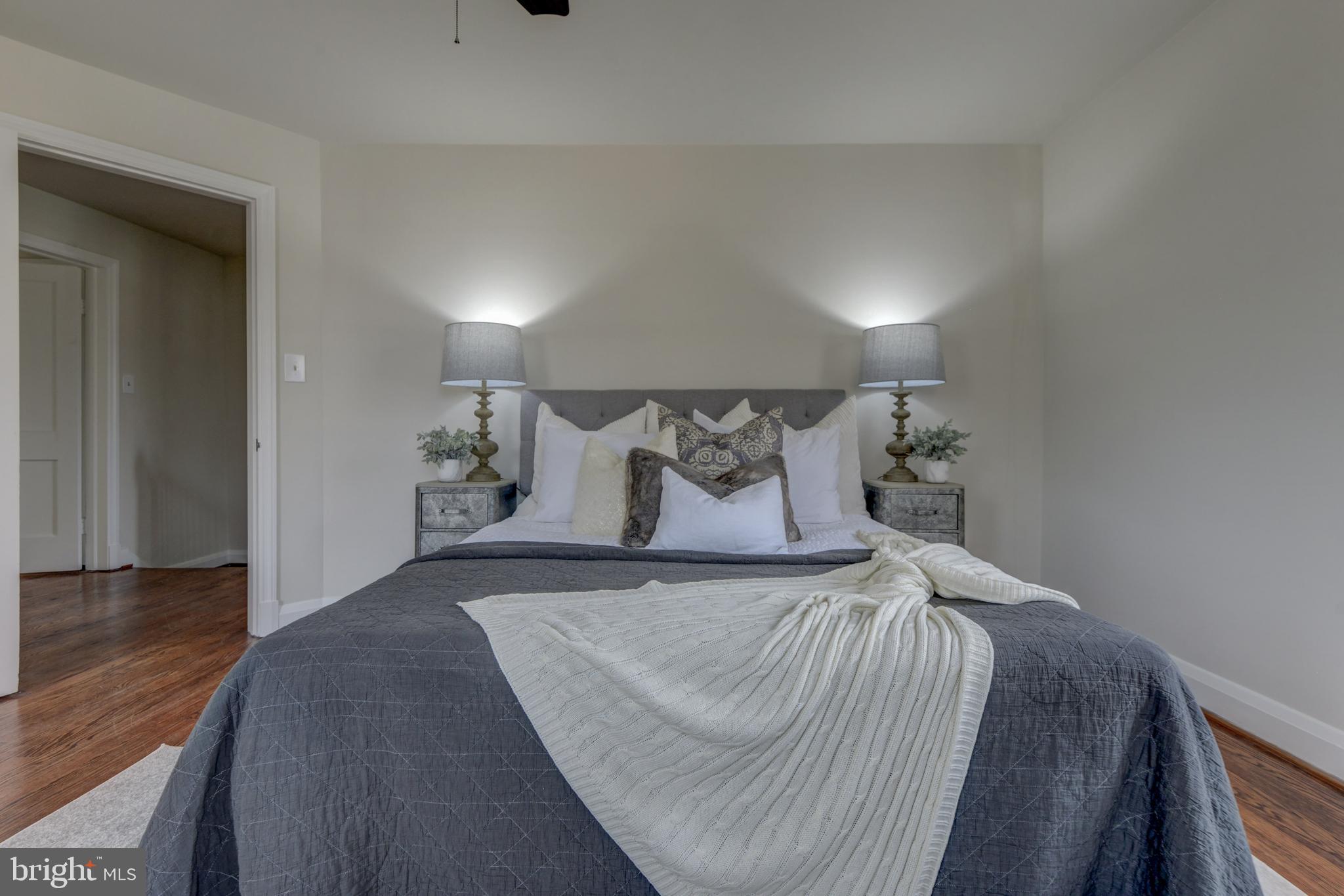6121 Regent Park Road Baltimore, MD 21228 - Photo 24 of 36 a bedroom with a bed and wooden floor
