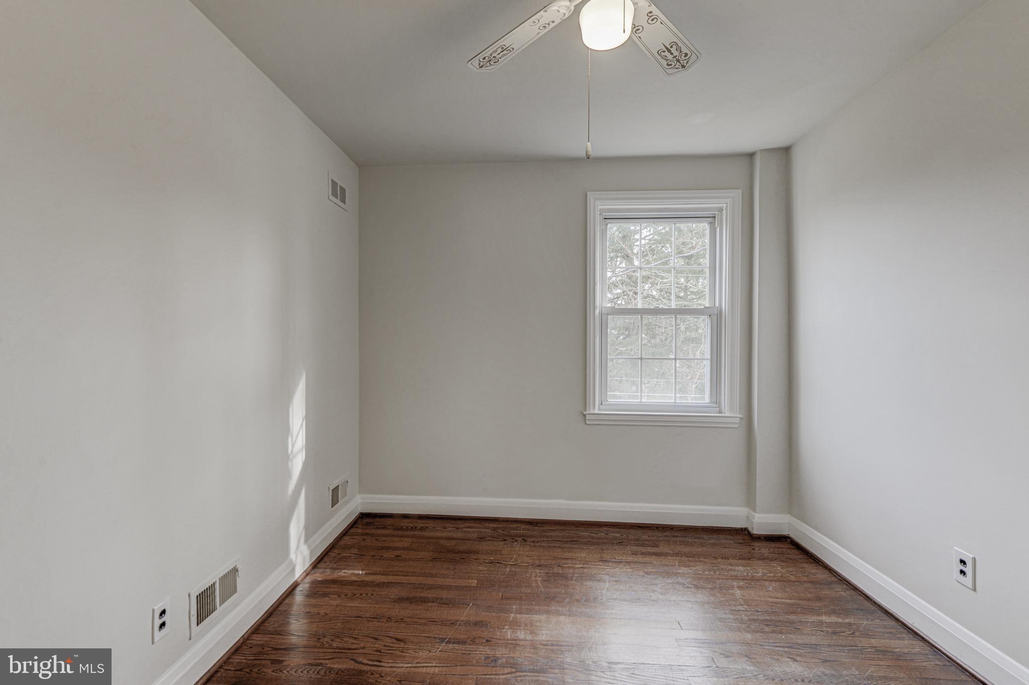 6121 Regent Park Road Baltimore, MD 21228 - Photo 28 of 36 a view of an empty room with wooden floor and a window