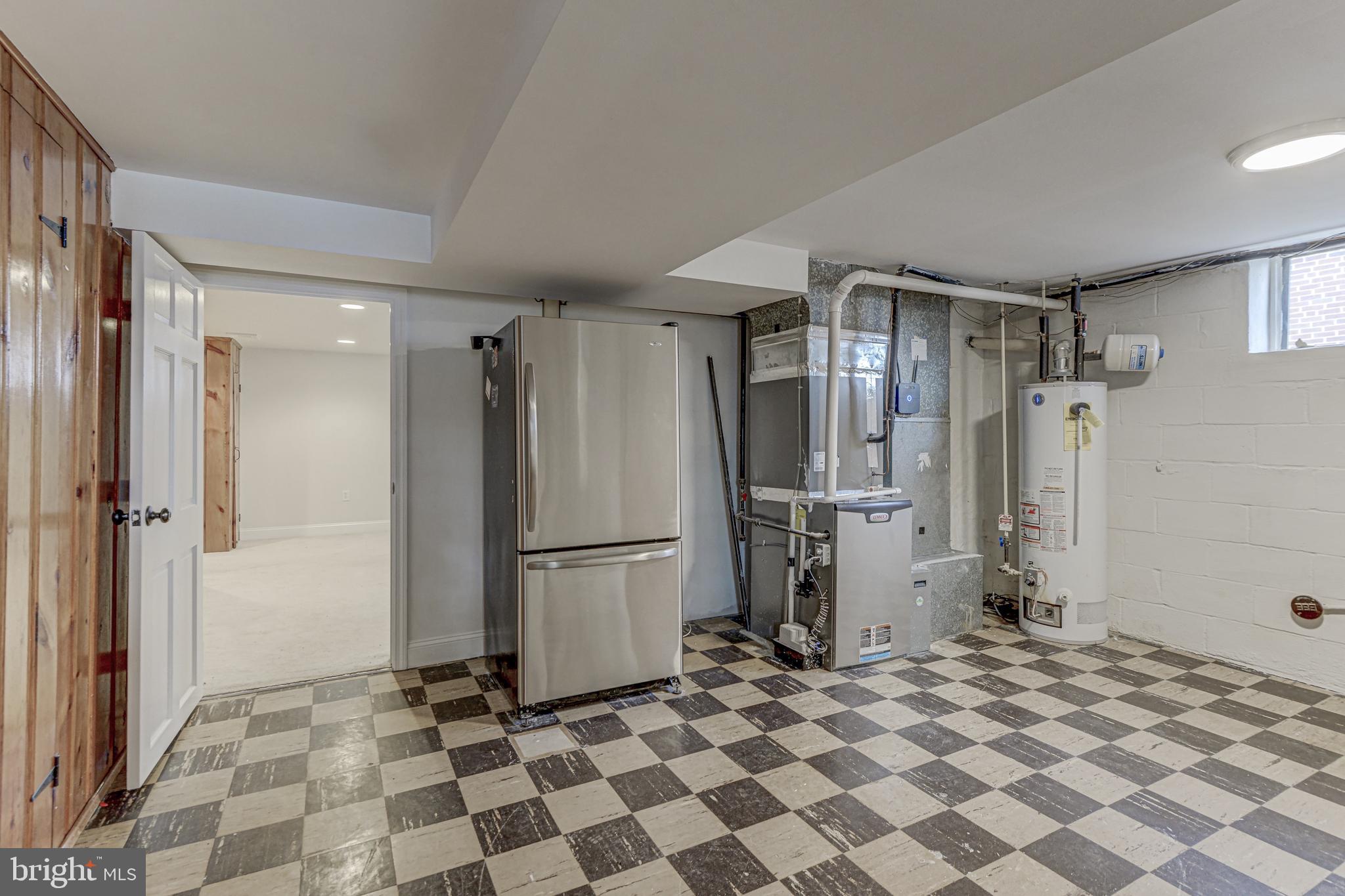 6121 Regent Park Road Baltimore, MD 21228 - Photo 34 of 36 a kitchen with a refrigerator and a stove top oven