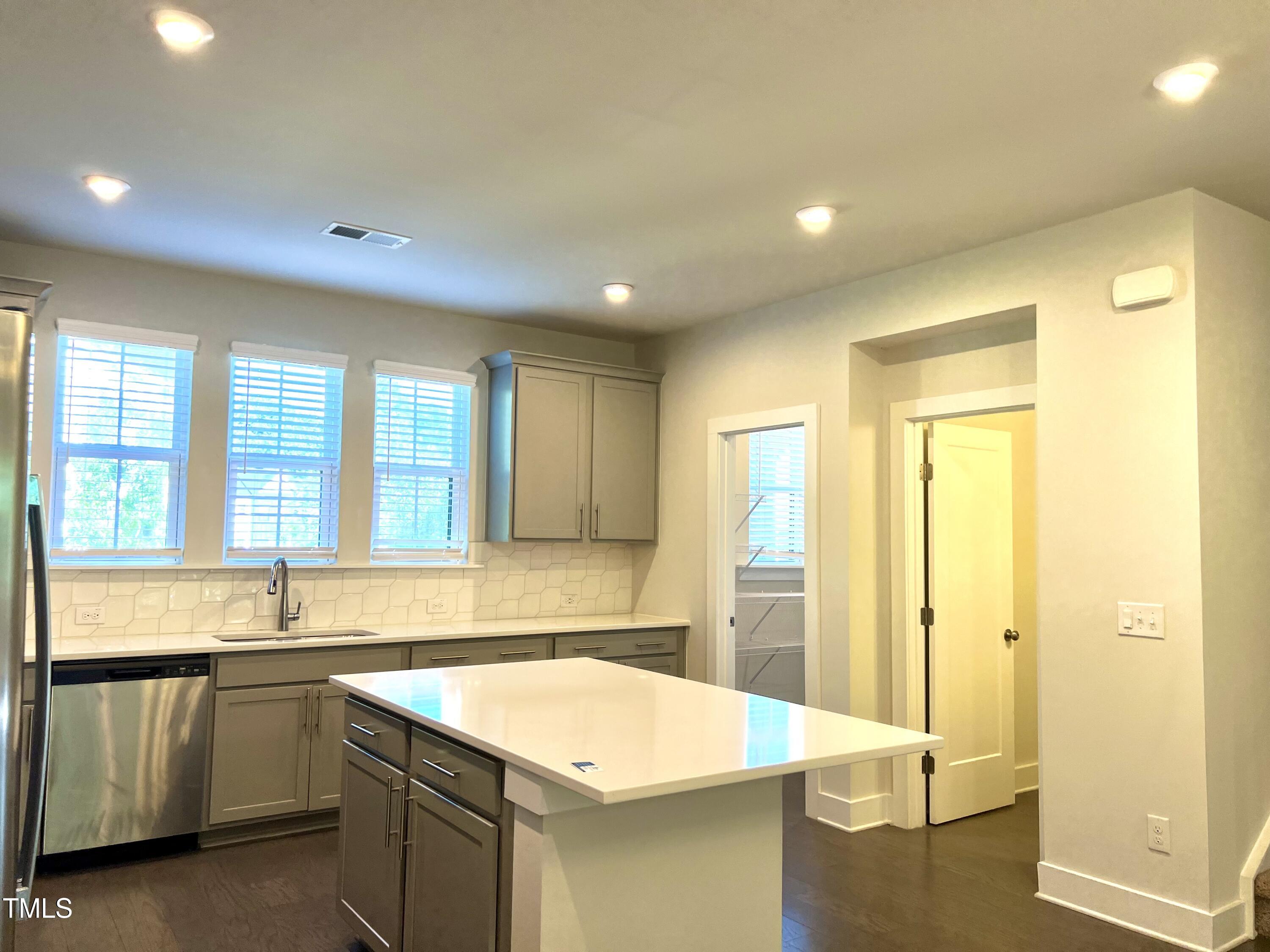 906 Waterside View Drive Raleigh, NC 27606 - Photo 11 of 27 a kitchen with a sink and large window